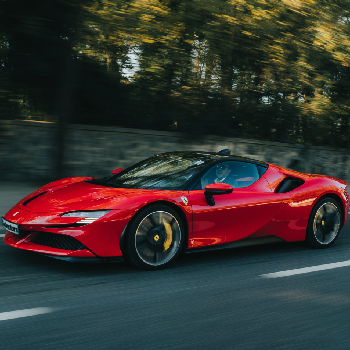 Picture of a red sports car running on the road